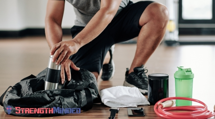 man removing workout supplements and accessories from gym bag